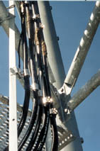 The #29X leads are bonded to 4/0 copper cables, which are connected to a horizontal bus on the tower structure.