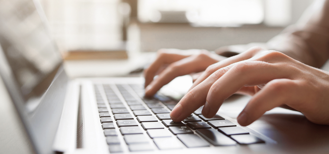 hands on a laptop keyboard