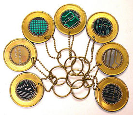 Circuit board keychain on round brass disk.