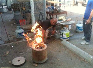 Artist Ben Harper doing a bronze pour.