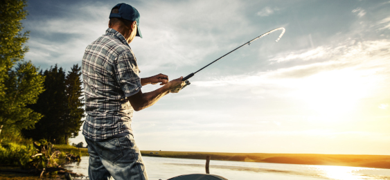 Man reeling in a fishing rod