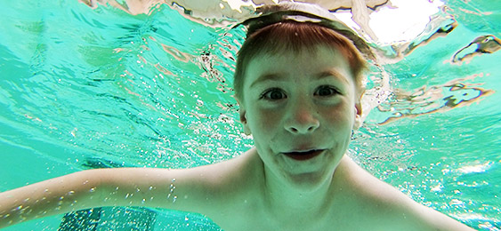 Kid underwater in swimming pool
