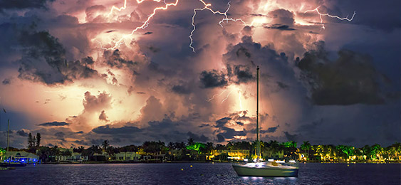 Sailboat with Bolts of Lightning Burst through Clouds