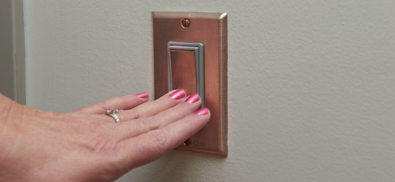 Hand on a Copper lightswitch