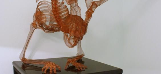 A skeleton sculpture made out of copper